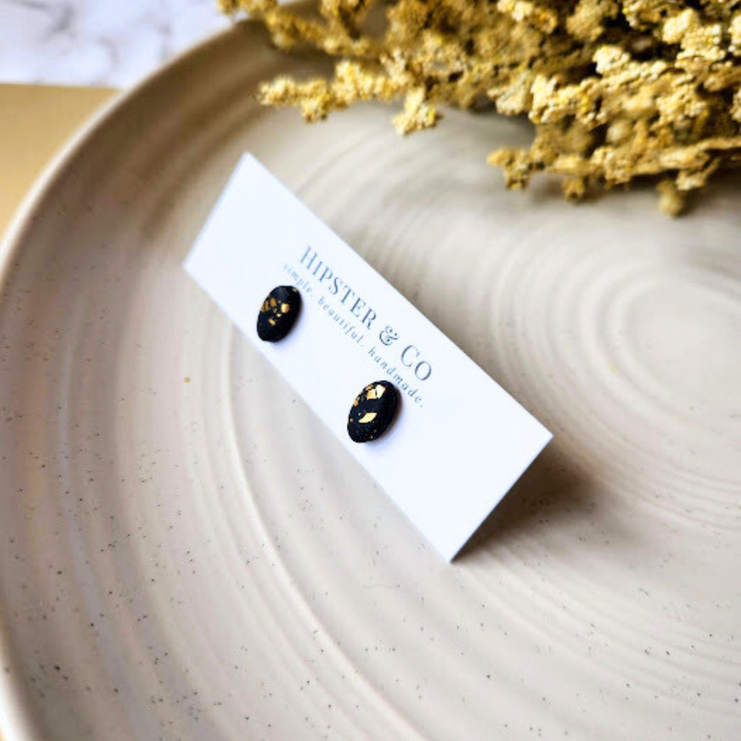 The Enza Black and Gold Oval Polymer Clay Stud Earrings