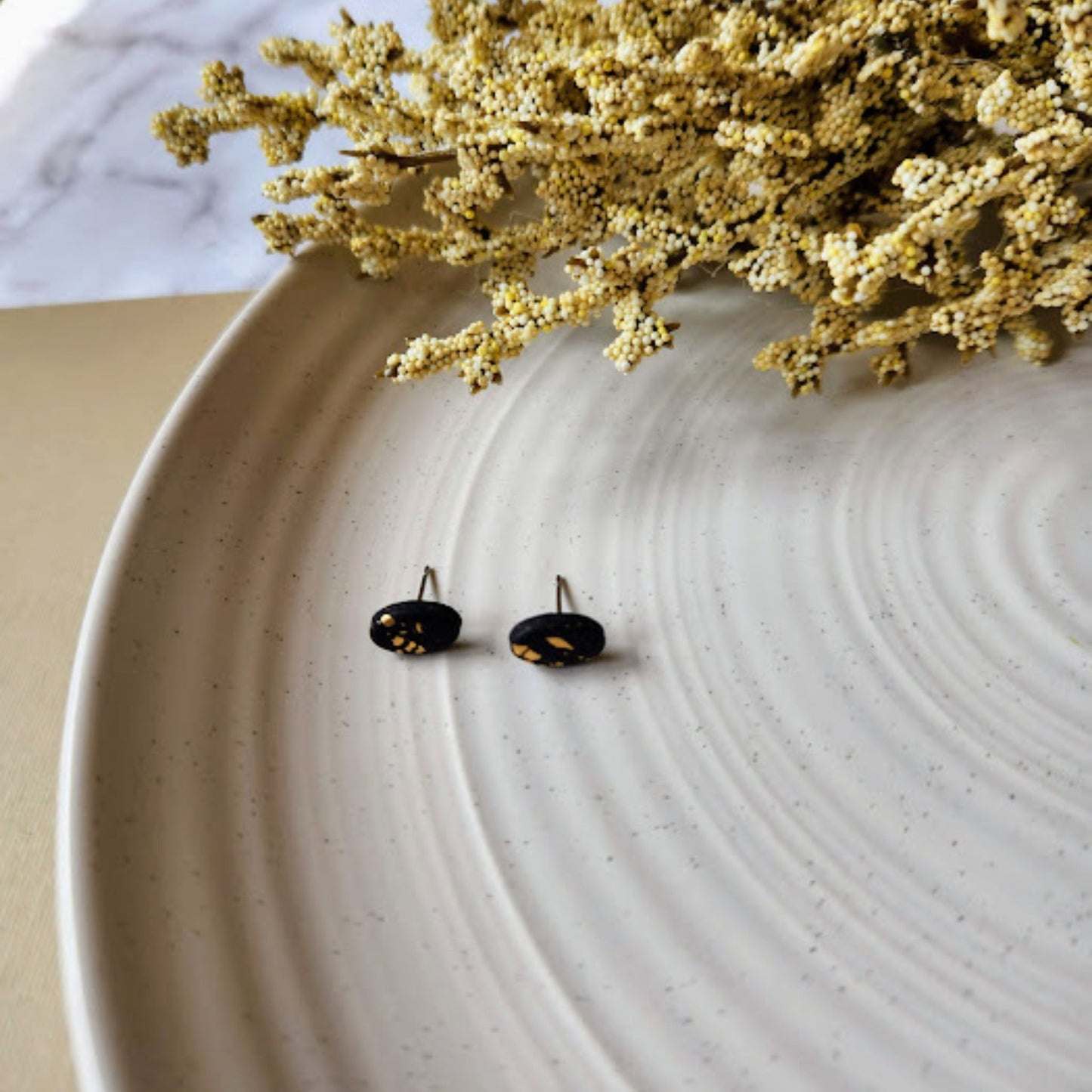 The Enza Black and Gold Oval Polymer Clay Stud Earrings